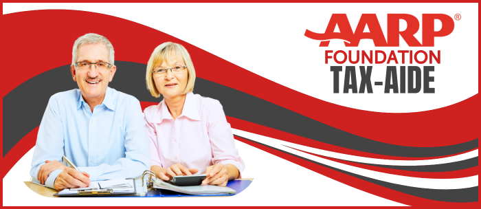 Image of a white couple in their sixties with tax forms in front of them. The AARP Foundation logo is on the right in red and a red/gray graphic wave in the background.