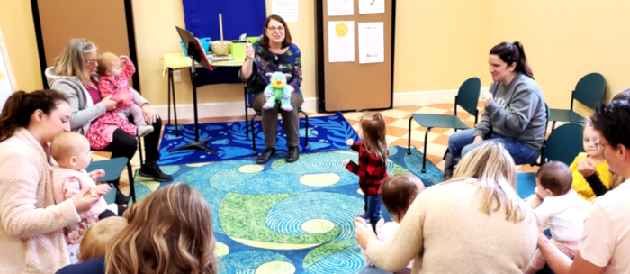 Photo of Lisa Scholl Hosting Storytime at Petoskey District Library with children ages 0-5 and their grownups